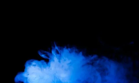 Abstract Blue Smoke Cloud on Black Background with Glowing Vapor Effect Stock Photos