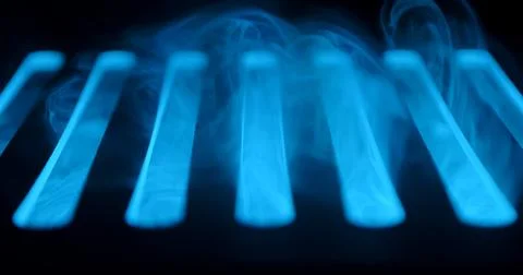 Abstract Blue Smoke Over Bars in Dark Atmosphere Stock Photos