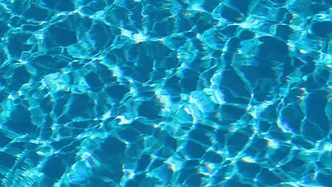 Abstract blue swimming pool water surface with gentle ripples, shimmering Stock Footage 345960483