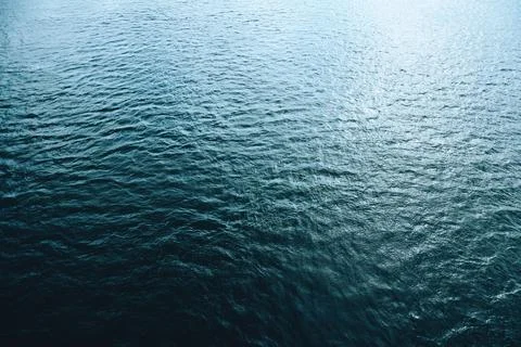 Abstract blue water texture with subtle light reflections and smooth ripple.. Stock Photos