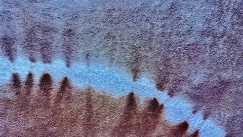 Abstract blue wave horizon diffusing across purple brown textured fabric back Stock Photos