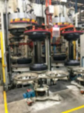 Abstract blur background of machine and tire at tire factory Stock Photos
