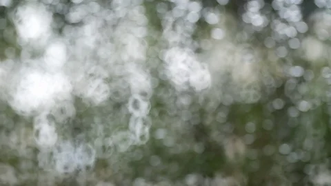 Abstract blur bokeh rain drops on glass window Stock Footage 93770697