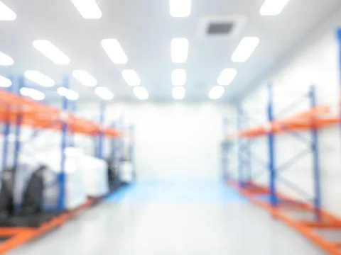 Abstract blur of empty orange and blue colors metal storage shelves, interi.. Stock Photos