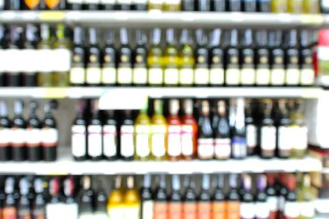 Abstract Blur or Defocus Background of Bottles of Wine on Shelf in Supermarke Stock Photos