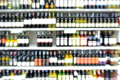 Abstract Blur or Defocus Background of Bottles of Wine on Shelf in Supermarke Stock Photos