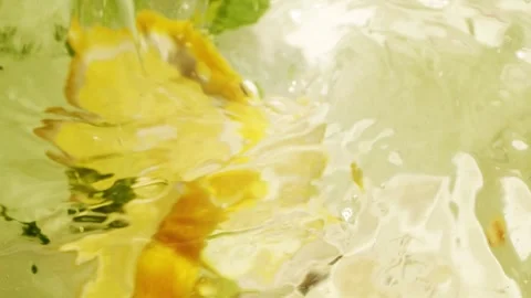 Abstract blur water surface motion, splash, ripples, lemon fruit and mint leaves Stock Footage 270687246