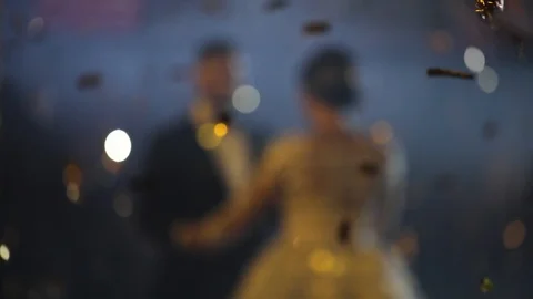 Abstract blured defocused motion. Young beautiful bride and groom dancing first  Stock Footage 105787613