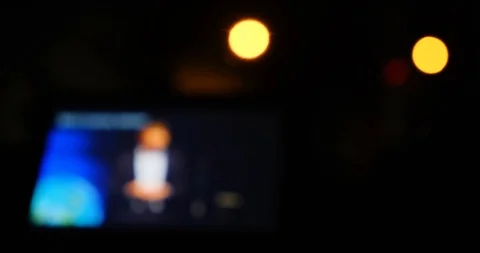 Abstract blurred and defocused TV show playing at night on a tablet Stock Footage 125186218