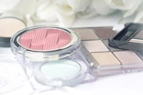 Abstract blurred background, cosmetics set and tulips on white. Macro shot, S Stock Photos