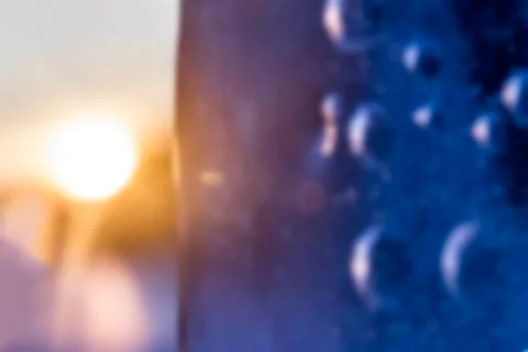 Abstract blurred background of an icy texture on the background of the sun. C Stock Photos