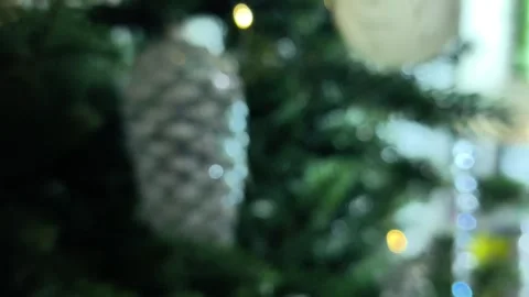 Abstract blurred background with silver pine cone on green Christmas tree. Stock Footage 347458452