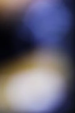 Abstract blurred background with soft blue and warm golden light gradients Stock Photos