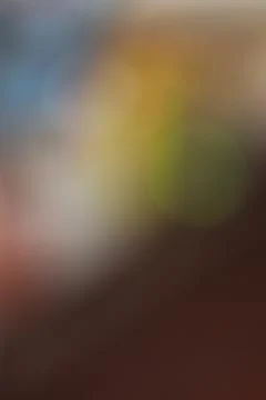 Abstract blurred background with soft golden and brown light gradients. Stock Photos