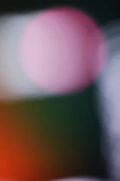 Abstract blurred background with soft pink and orange light bokeh circles Stock Photos