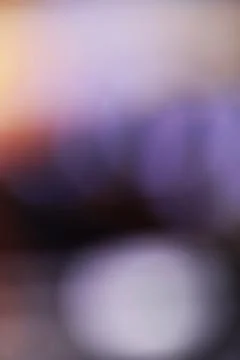 Abstract blurred background with soft purple and orange light gradients Stock Photos