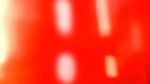 Abstract blurred background, with vibrant red, tones and white highlights Stock Photos