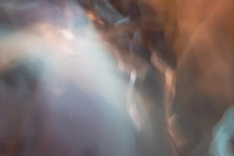 Abstract blurred background with warm and cool light leaks 스톡 사진