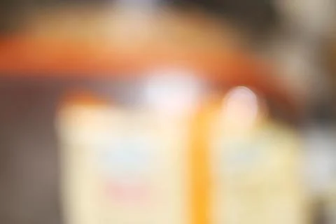 Abstract blurred background with warm orange and soft yellow light bokeh ef.. Stock Photos