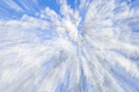 Abstract blurred background with white bokeh dots on a soft blue sky. Stock Photos