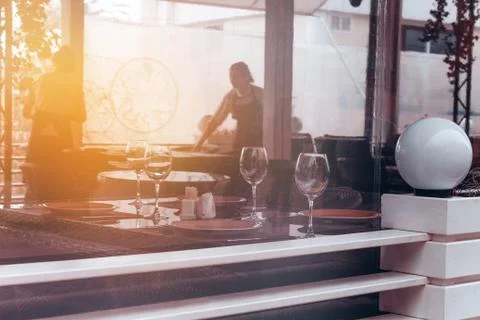 Abstract blurred background   window of the restaurant with wine glasse and w Stock Photos