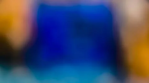 Abstract blurred blue background with warm bokeh edges Foto stock