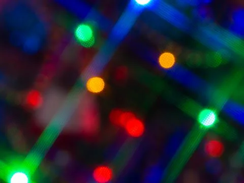 Abstract blurred bokeh background multicolor lights with cross filter.  Stock Photos