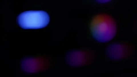 Abstract blurred bokeh lights on dark background with blue and multicolor g.. 库存影片 334285498