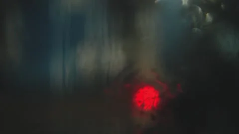 Abstract blurred city lights seen through a rain-covered car window at night Stock Footage 341756186