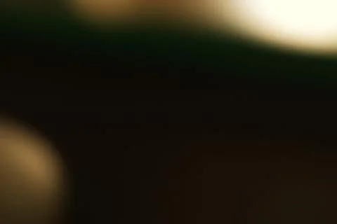 Abstract Blurred Dark Background with Hints of Gold and Green Stock Photos