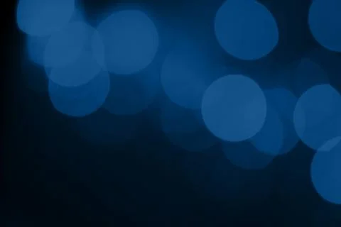 Abstract blurred dark blue background with beautiful bokeh effect. Stock Photos
