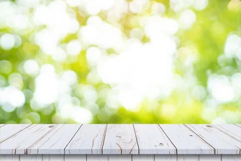 Abstract blurred garden and green leaf with wooden table counter background f Stock Photos