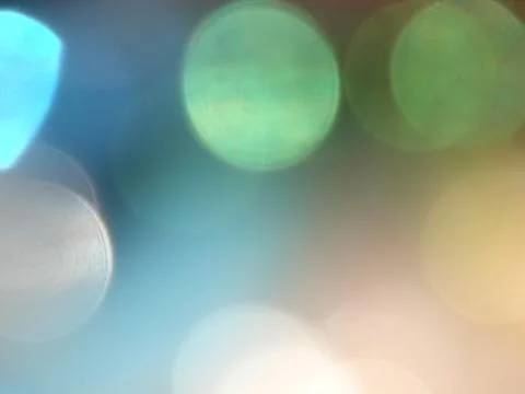 Abstract blurred glowing light particles of shades of light blue Stock Photos