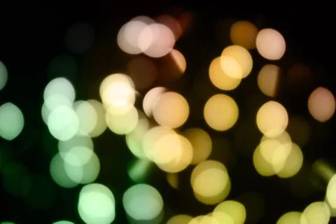 Abstract blurred glowing light particles of shades of green and yellow Stock Photos
