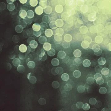 Abstract blurred glowing light particles of shades of green Foto stock
