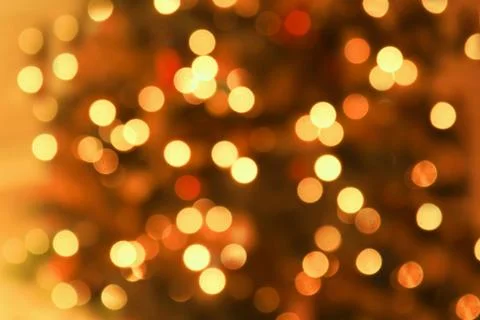 Abstract blurred glowing light particles of shades of gold and red Foto stock