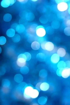 Abstract blurred glowing light particles of shades of blue Stock Photos