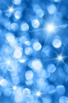 Abstract blurred glowing light particles of shades of blue Stock Photos