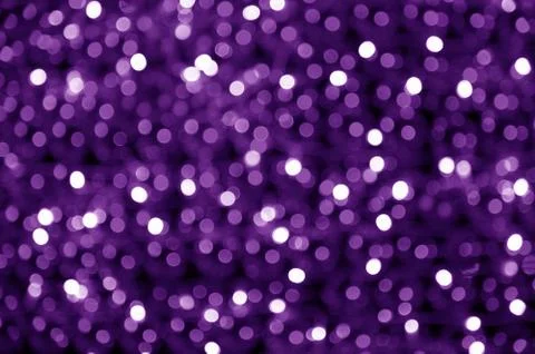 Abstract blurred glowing light particles of shades of purple Stock Photos