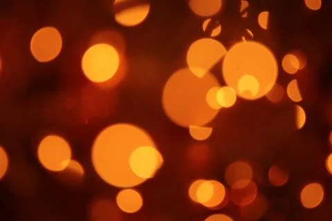 Abstract blurred glowing light particles of shades of light gold and red Foto stock