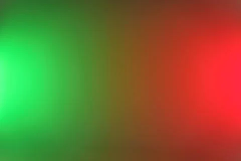 Abstract blurred gradient background featuring bright green and red light fla Stock Photos