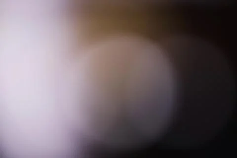 Abstract blurred light circles on a dark background with soft bokeh effect Stock Photos