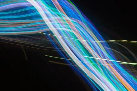 Abstract blurred light lines on black background. Stock Photos