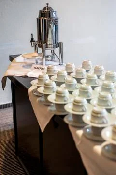 Abstract blurred many rows of coffee tea cups with coffee dispenser Stock Photos