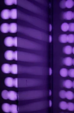 Abstract blurred out of focus neon purple bokeh light pattern background Stock Photos