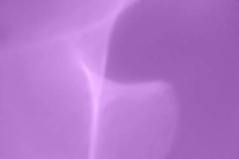 Abstract blurred rainbow glitter background. Purple background. Stock Photos