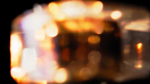 Abstract blurred reflection of a glass object rotating on black background Stock Footage 345518128