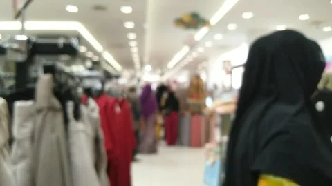 Abstract blurred scene inside retail Fashion store with Hijab woman side view Stock Footage 242469500