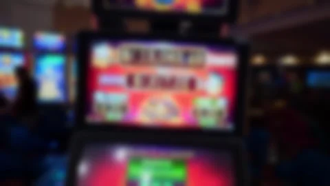 Abstract blurred slot machine with bright colorful screens in casino Stockbeeldmateriaal 322523010