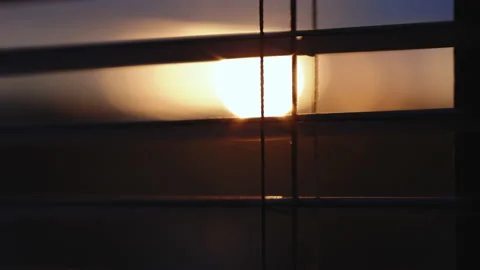 Abstract blurred sunlight goes through the window blinds and mosquito wire Video stock 196002314